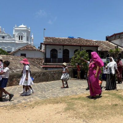 Sri Lankan teacher in pink saree on a school trip
